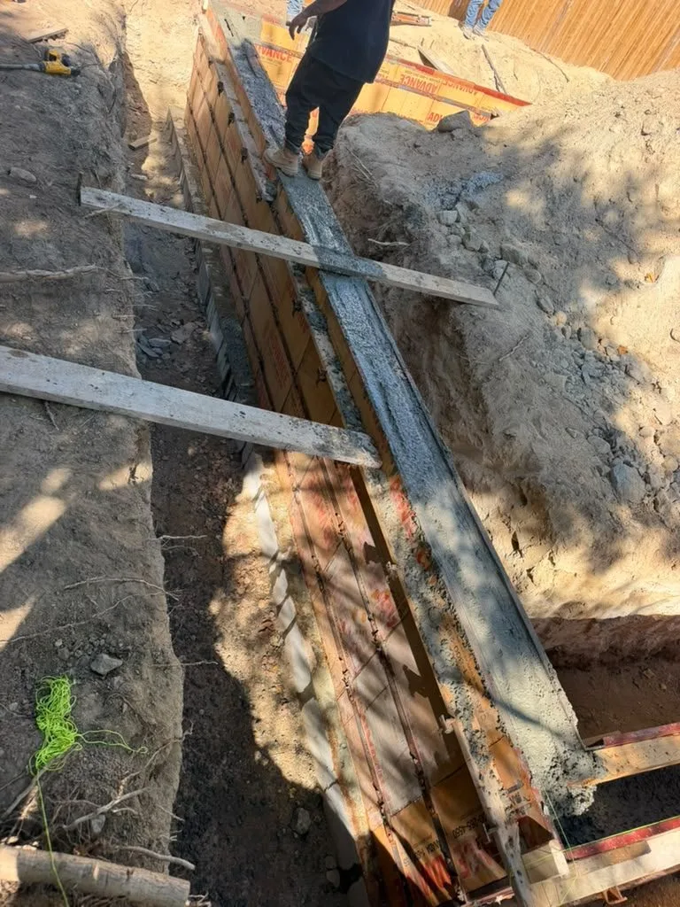 Crew checking braced foundation wall forms before a pour
