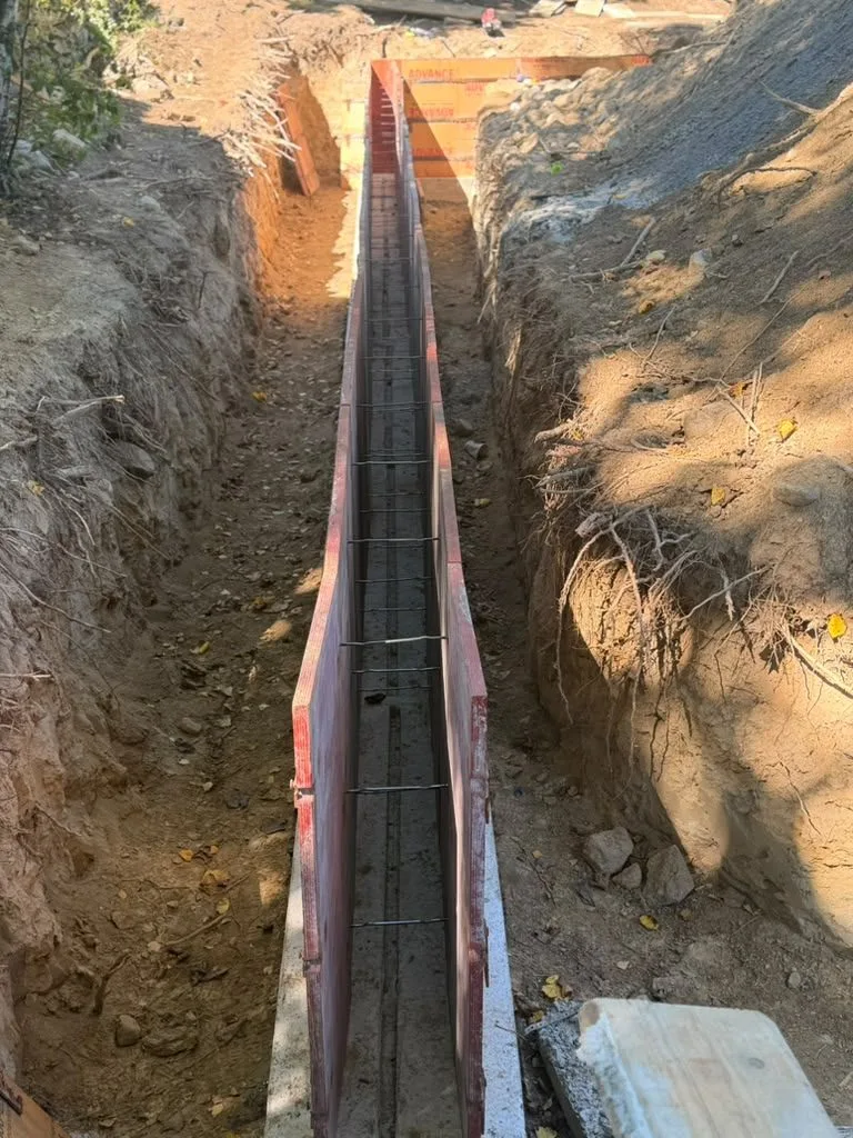 Footing forms with rebar in a deep trench