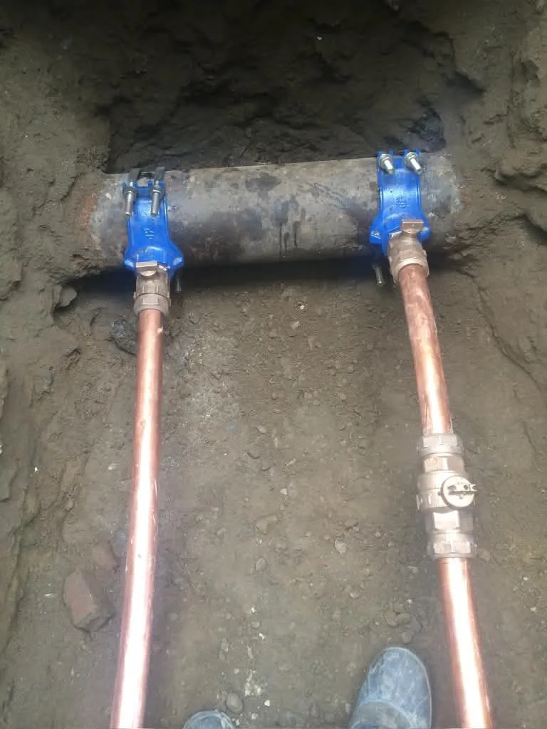 New copper water service lines with valves in an open trench